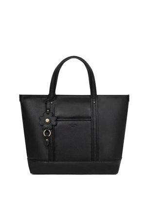 Czarna skórzana torba typu tote z podwójnymi uchwytami, przednią kieszenią oraz kwiatowym brelokiem z złotym wykończeniem.