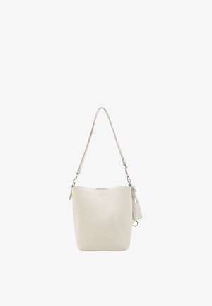 Cream-colored leather bucket bag with adjustable shoulder strap and small attached tag hanging on a white background.