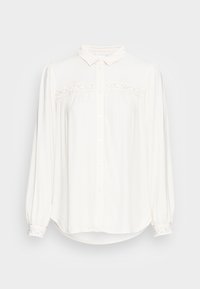 Vit skjorta med lång ärm, med spetsdetalj över bröstet och spetsaccent på ärmsluten. Slät textur.