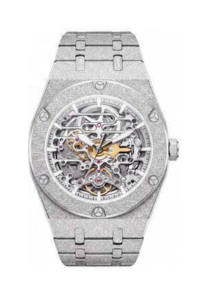 Luxury silver wristwatch with exposed mechanical gears and screws visible through the transparent dial, metallic strap with linked segments.