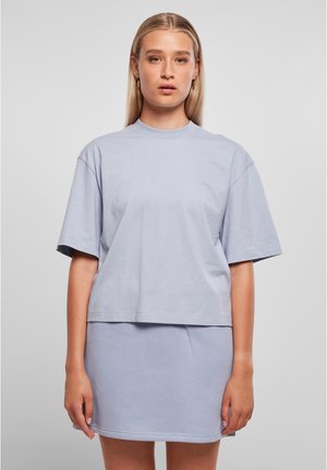Light blue cotton t-shirt with short sleeves and a slightly cropped hem, paired with a matching mini skirt. Soft texture and relaxed fit.