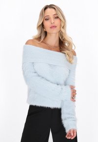 Maglione azzurro chiaro off-the-shoulder con una morbida e pelosa texture e un collo a coste. Presenta maniche lunghe e un orlo cropped.