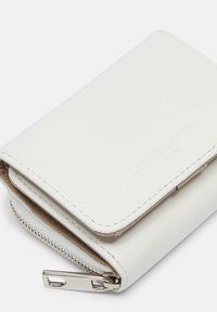 White leather wallet with a smooth texture, zippered compartment, and embossed brand name. Compact, rectangular design with silver hardware.