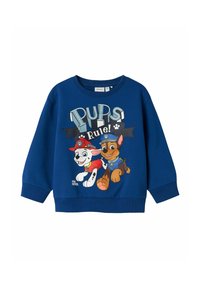 Felpa blu con polsini e collare a costine, che presenta una grafica colorata di due cani cartoni animati e il testo "I CAGNOLINI Regalano!"