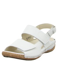 White leather sandals featuring a cork sole, adjustable ankle strap, and open-toe design with cutouts for ventilation.