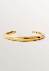 Pulsera de pulsera de color dorado con un diseño suave y redondeado. Hecha de metal, presenta un estilo minimalista sin patrones ni embellishments.