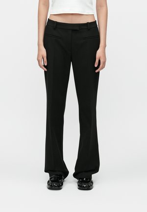 Black wide-leg trousers feature a tailored design, smooth texture, front pockets, and a flat waistband with belt loops.