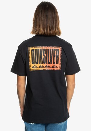 Black cotton t-shirt featuring a large, colorful Quiksilver logo on the back, with an orange to yellow gradient and a textured border.