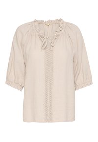 Blouse beige clair avec un col en volants froncés, détail à nouer et manches courtes bouffantes. Présente un panneau central brodé.