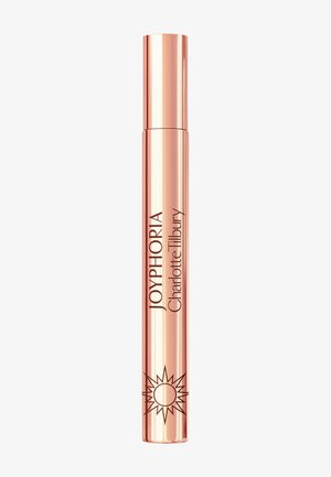 Roségoldene zylindrische Kosmetiktube mit der Aufschrift JOYPHORIA Charlotte Tilbury und einem Sonnenstrahl-Symbol nahe dem Boden.