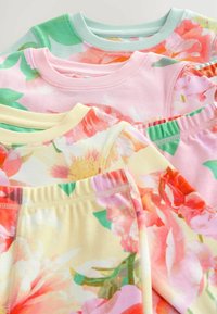 Four short-sleeve shirts in pastel colors: mint green, pink, and yellow, with floral patterns in shades of pink, orange, and green.