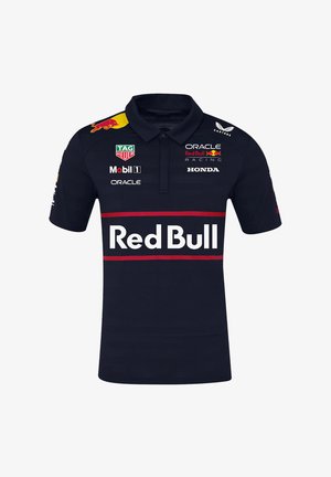 Ciemnoniebieska koszulka polo z kołnierzykiem, z czerwoną paskiem i logo "Red Bull". Logo marki nadrukowane na klatce piersiowej i rękawach. Krótkie rękawy.