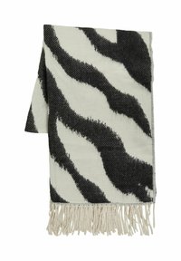 Kudottu viltti mustavalkoisella seeprakuvioinnilla, jossa on teksturoitu kangas ja hapsutetut reunat lisäyksinä.