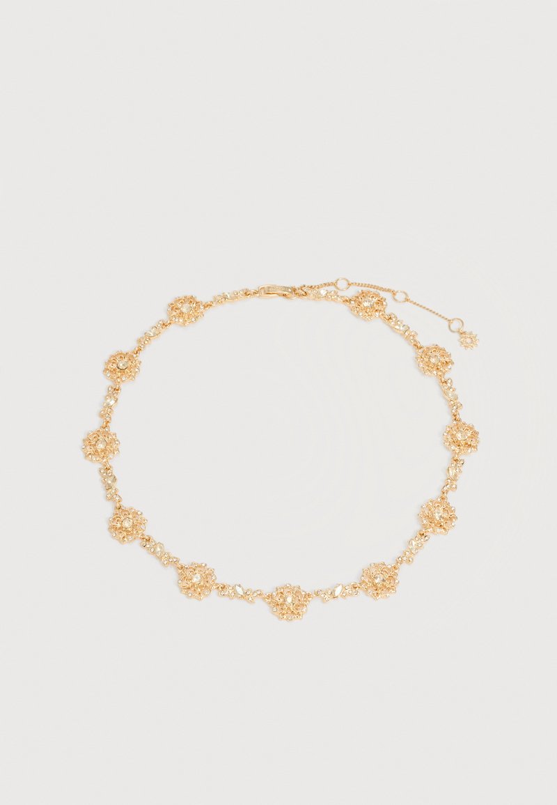 Κολιέ αλυσίδα με ανθικά μοτίβα σε χρυσό τόνο, με μικρές κρυστάλλινες λεπτομέρειες και ρυθμιζόμενο κούμπωμα σε ανοιχτό φόντο.