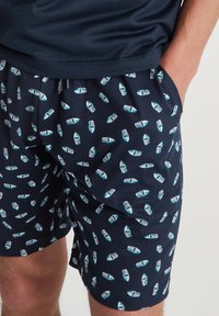 Marine zwemshorts met een patroon van kleine, kleurrijke boten. Gemaakt van lichtgewicht stof met een elastische tailleband en zijzakken.