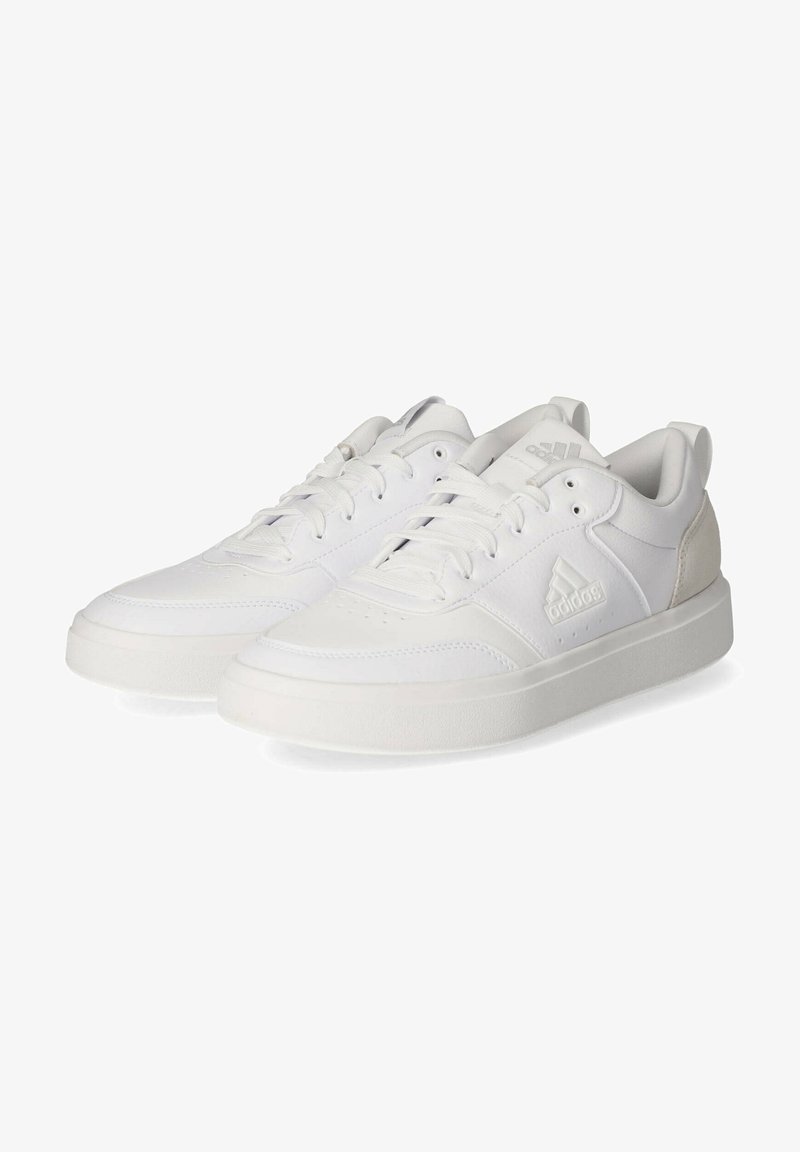 White athletic shoes with a smooth leather upper, lace closure, and textured rubber soles; features a small logo and contrasting accents.