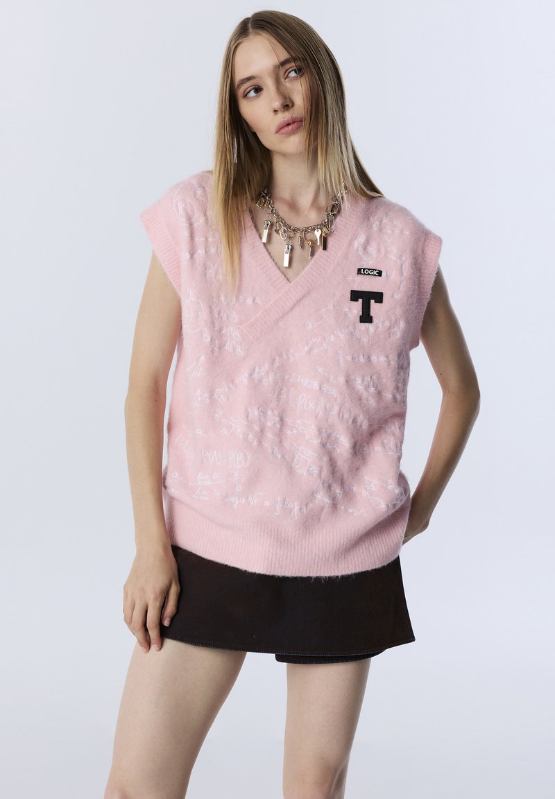 Pink sleeveless sweater with a V-neck, featuring a textured pattern of white handwritten symbols and a black logo patch on the chest.