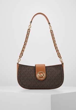 Brązowa designerska torba na ramię z wzorem monogramu, klapą z jasnobrązowej skóry, złotym logo MK oraz złotym, skórzanym, plecionym łańcuchem na białym postumencie wystawowym.