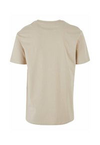 Tricou bej cu mânecă scurtă, din material moale de bumbac, guler rotund, croială relaxată, finisaj curat fără cusături sau modele vizibile.