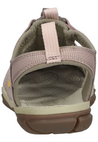Tan and pink sandal with a textured fabric upper, adjustable back strap, and cushioned insole. Features a rubber sole for traction.