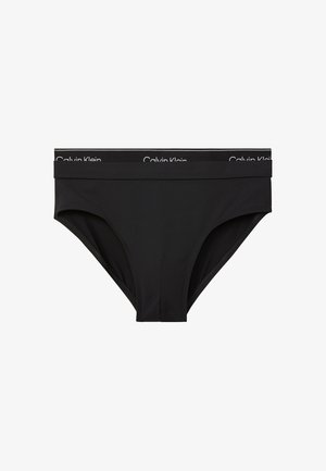 Schwarzer Calvin Klein Bikini-Slip im Brief-Stil mit gebrandetem Taillenbund in weißer Schrift, flach auf weißem Hintergrund gezeigt.
