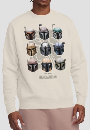 Beige sweatshirt showing nine Mandalorian helmets in three rows with "Star Wars The Mandalorian" text below.