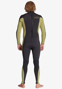 Black and olive wetsuit with long sleeves, fitted design, and back zipper. Reinforced seams and logo detail on the back.