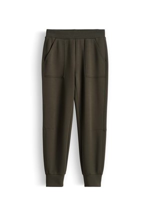 Pantalon de survêtement fuselé vert olive foncé avec taille élastique, poches plaquées devant et poignets côtelés.
