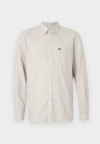 Long-sleeved checkered shirt in light beige and brown, made of cotton, featuring a button-down collar and a small brand logo on the chest.