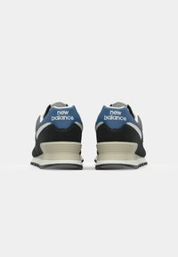 Black and gray athletic shoes with a blue heel and white accents, featuring a textured upper and a cushioned, lighter-colored sole.