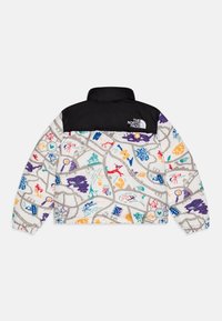 Vadderad jacka med en svart övre del och en färgglad mönstrad nedre del med olika grafiska illustrationer och dragkedja.