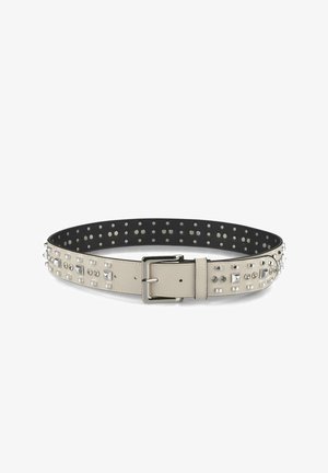Beige leather belt with silver studded accents and a silver buckle; textured surface; smooth black interior with circular perforations.