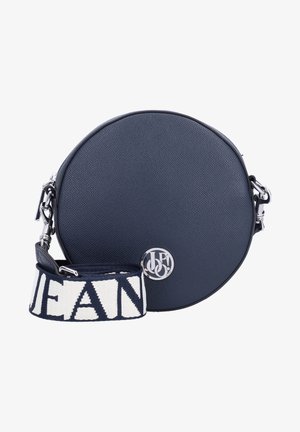 Round navy blue leather crossbody bag with silver logo and detachable navy and white strap featuring large text design.