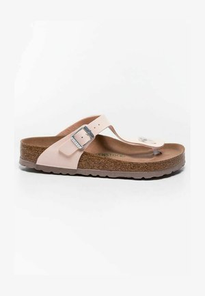 Light pink thong sandals with a silver buckle, cork footbed, and textured brown sole. Flat design with a minimalist aesthetic.