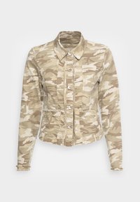 Camo jacket in beige tones featuring a button-up front, two front pockets, and frayed edges. Made of textured fabric with a collared neckline.