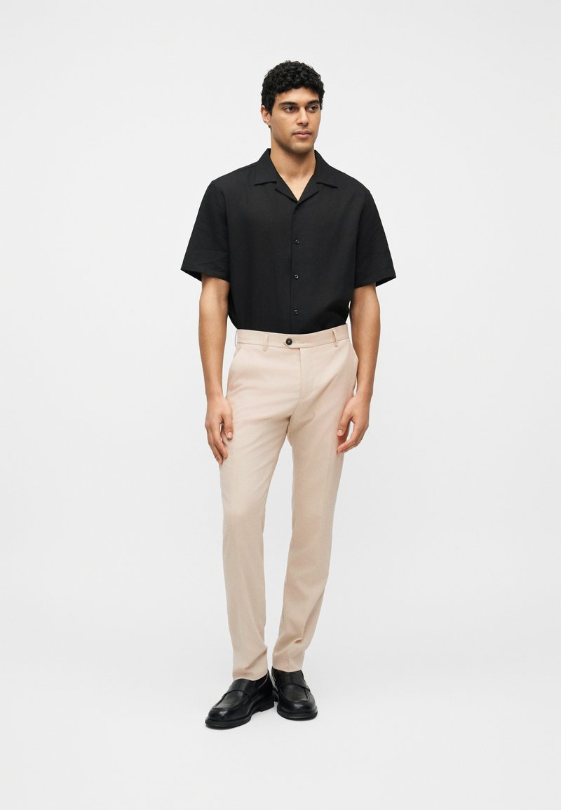 black dress shirt beige pants Beige and black suit