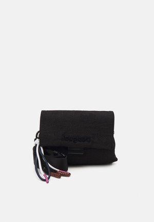 Black textured rectangular crossbody bag with flap closure, brand name embossed, and multi-color drawstring cords attached on the side.