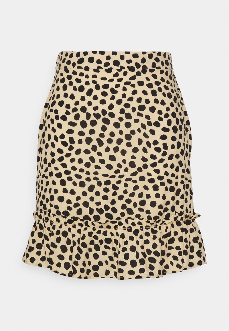 Jupe beige avec des pois noirs irréguliers et un ourlet à volants en bas.