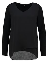 Haut noir à manches longues avec un col en V, un ourlet asymétrique, une couche inférieure texturée contrastante et un tissu supérieur lisse.