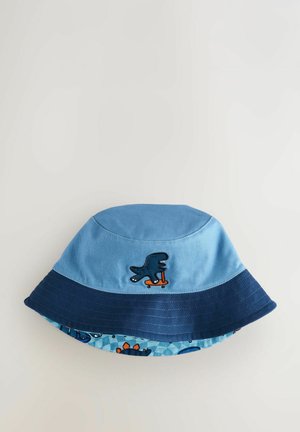 Blauer Baumwollbucket-Hut mit dunkelblauem Rand, ausgestattet mit einem Cartoon-Dinosaurier auf einem Skateboard, strukturiertem Stoff und kontrastierendem gemustertem Innenfutter.