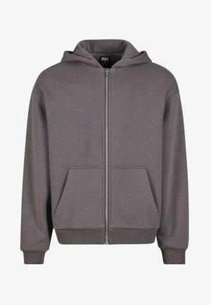 Grauer Zip-Up-Hoodie mit Kängurutasche, gerippten Bündchen und Saum. Hergestellt aus weicher, glatter Stoffqualität. Mit einer verstellbaren Kapuze.