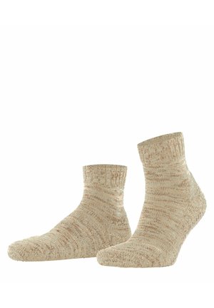 Paire de chaussettes beige en laine texturée, longueur cheville, présentées côte à côte sur un fond blanc.