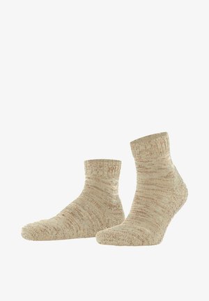 Paire de chaussettes beige en laine texturée, longueur cheville, présentées côte à côte sur un fond blanc.