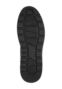 Suela de goma negra con patrón de textura. Presenta un leve tacón elevado y surcos rectangulares distintos para tracción.