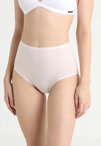 High-waisted, light pink briefs made of a smooth, stretchy fabric with a clean waistband and seamless sides for comfort and fit.
