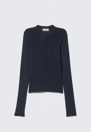 Navy blue long-sleeve top made from a soft fabric, featuring a round neckline, button placket, and fitted design with a straight hem.