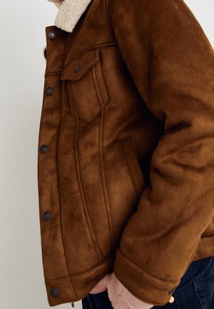 Brown faux suede jacket with a shearling collar, featuring front button closures, side pockets, and stitched detailing.