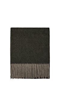Couverture en laine vert foncé avec une surface texturée et un bord frangé beige en bas. Forme rectangulaire et design minimaliste.