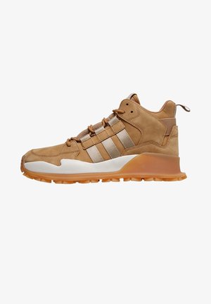 Tan high-top sneaker with beige stripes, lace-up front, white midsole, and gum rubber outsole, designed for casual and outdoor wear.