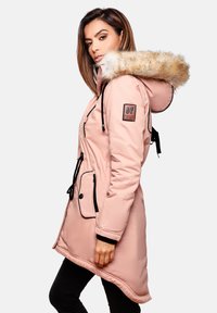 Pink long parka jacket with a fur-lined hood, adjustable drawstrings, black accents, and a logo patch on the sleeve. Features side pockets.